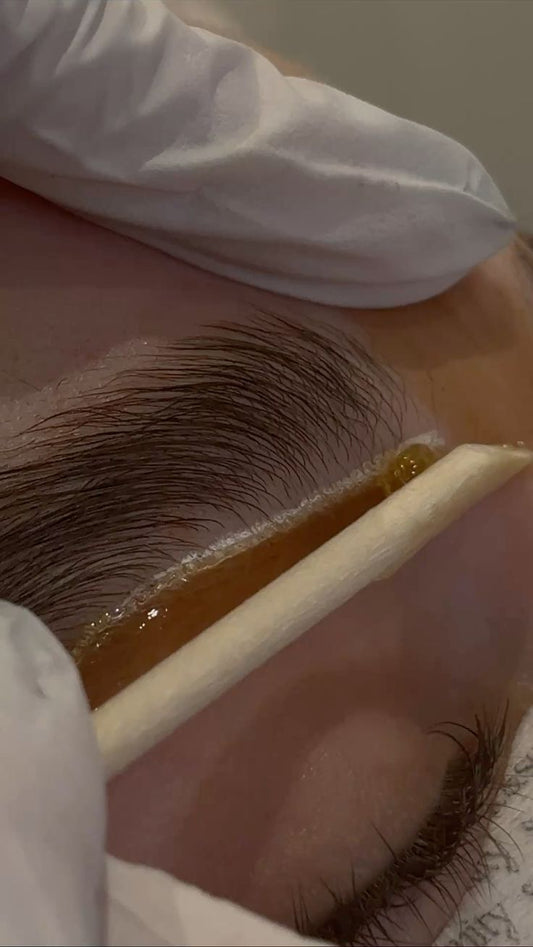 Client receiving eyebrow waxing and tinting at Beauty Bar by Mare in Spring, TX