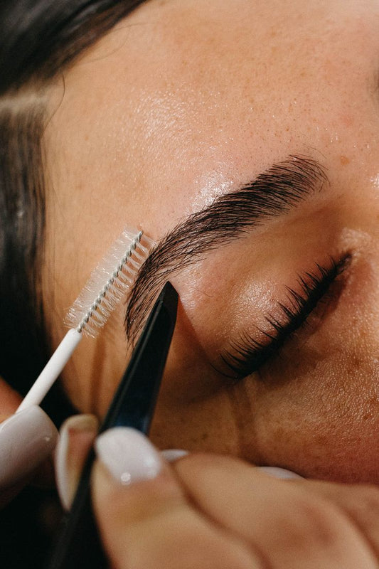 Close-up of perfectly shaped eyebrows after professional shaping at Beauty Bar by Mare in Spring, TX
