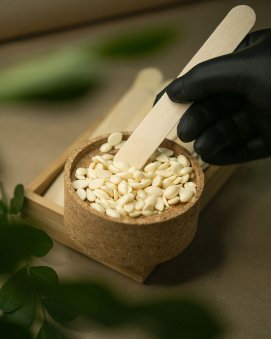 Esthetician applying soft wax during a Brazilian wax service at Beauty Bar by Mare in Spring TX.